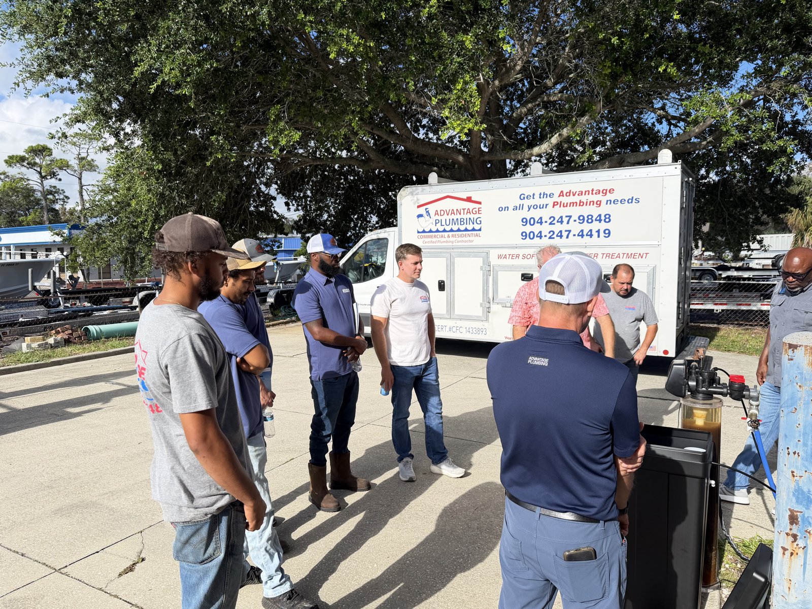 Advantage Plumbing team taking part in an outdoor Coast Pump water-treatment training demonstration