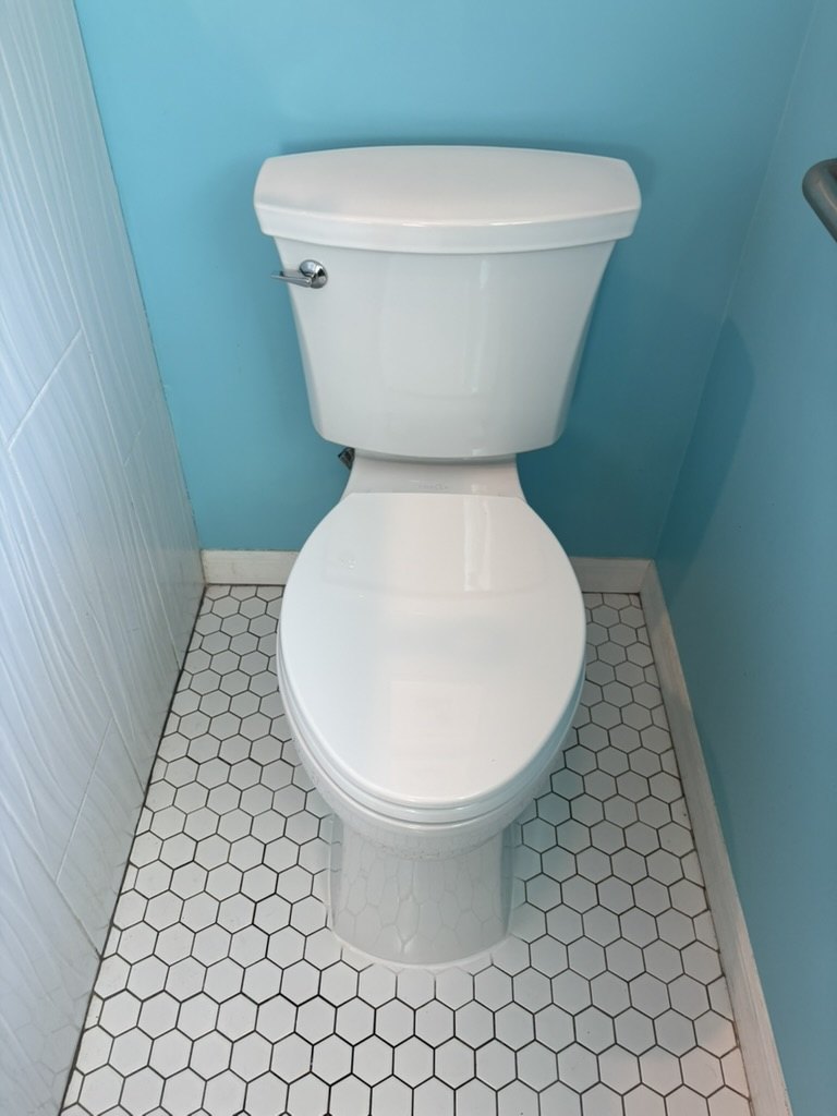 Customer-provided replacement toilet installed with the surrounding bathroom floor cleaned