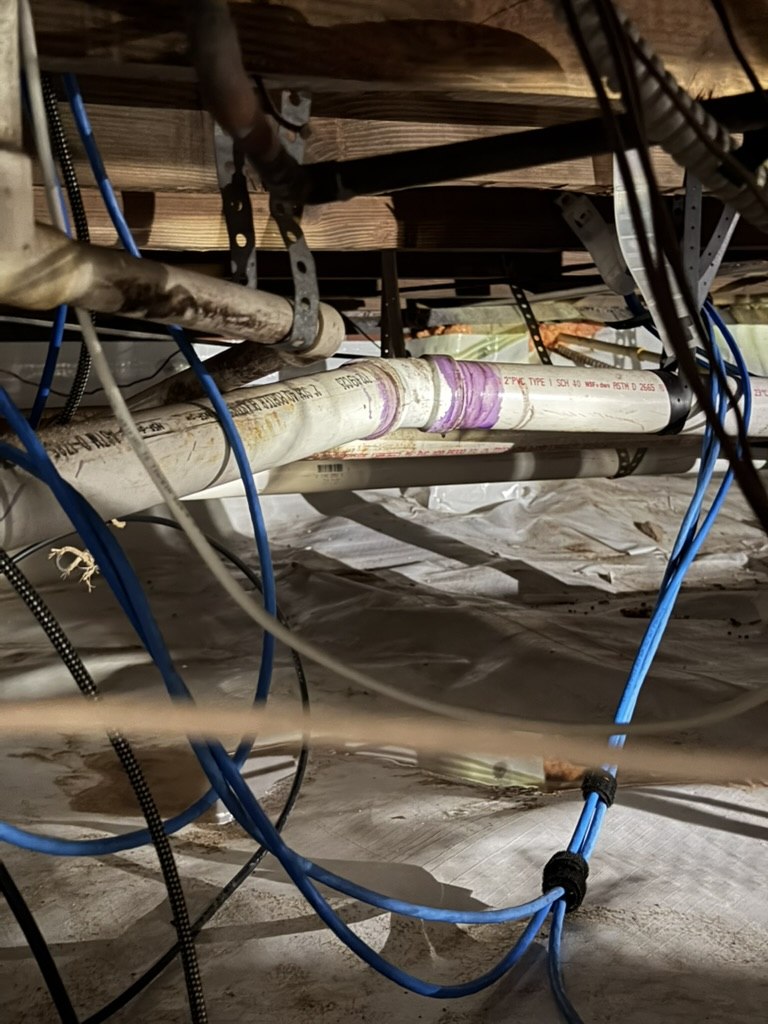 Drain piping and surrounding services in the building crawlspace