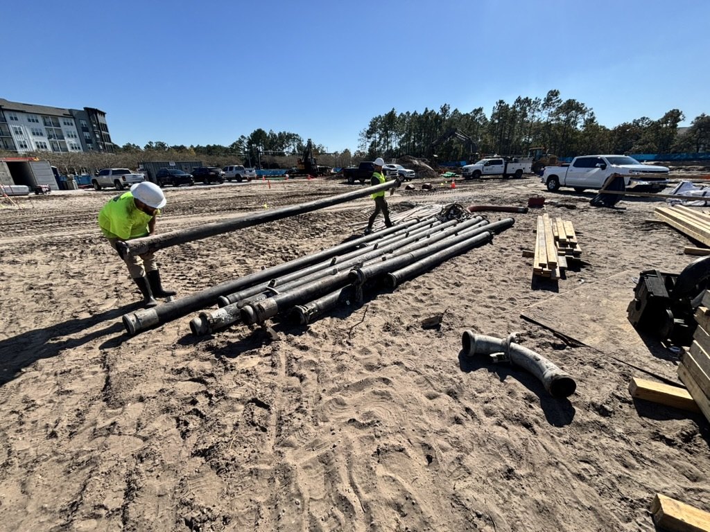Advantage Plumbing crew gathering wellpoint header piping during dismantling at the Nocatee project