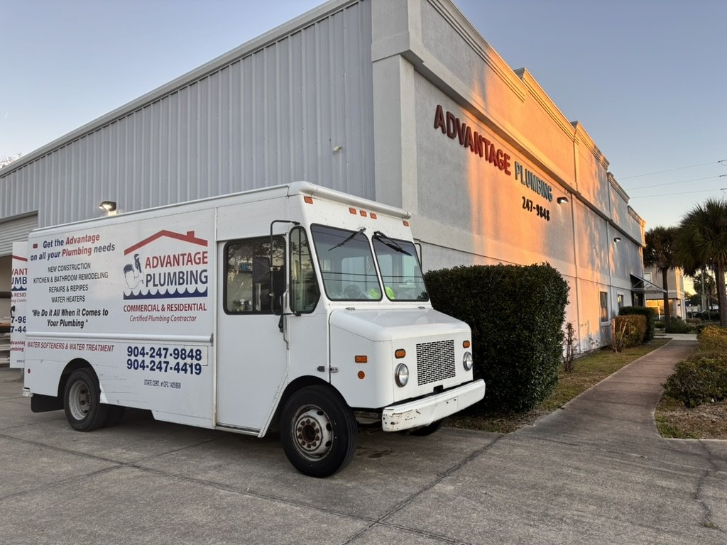 Morning sunlight on the Advantage Plumbing shop and a company service truck