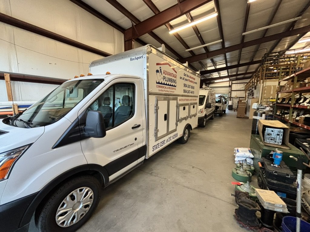 Advantage Plumbing service vehicles and equipment inside the shop