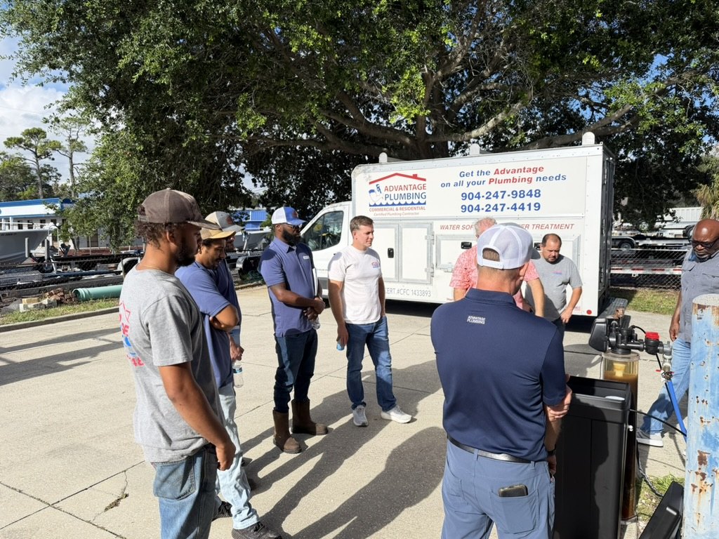 Advantage Plumbing team outside the Atlantic Beach shop beside a company service truck