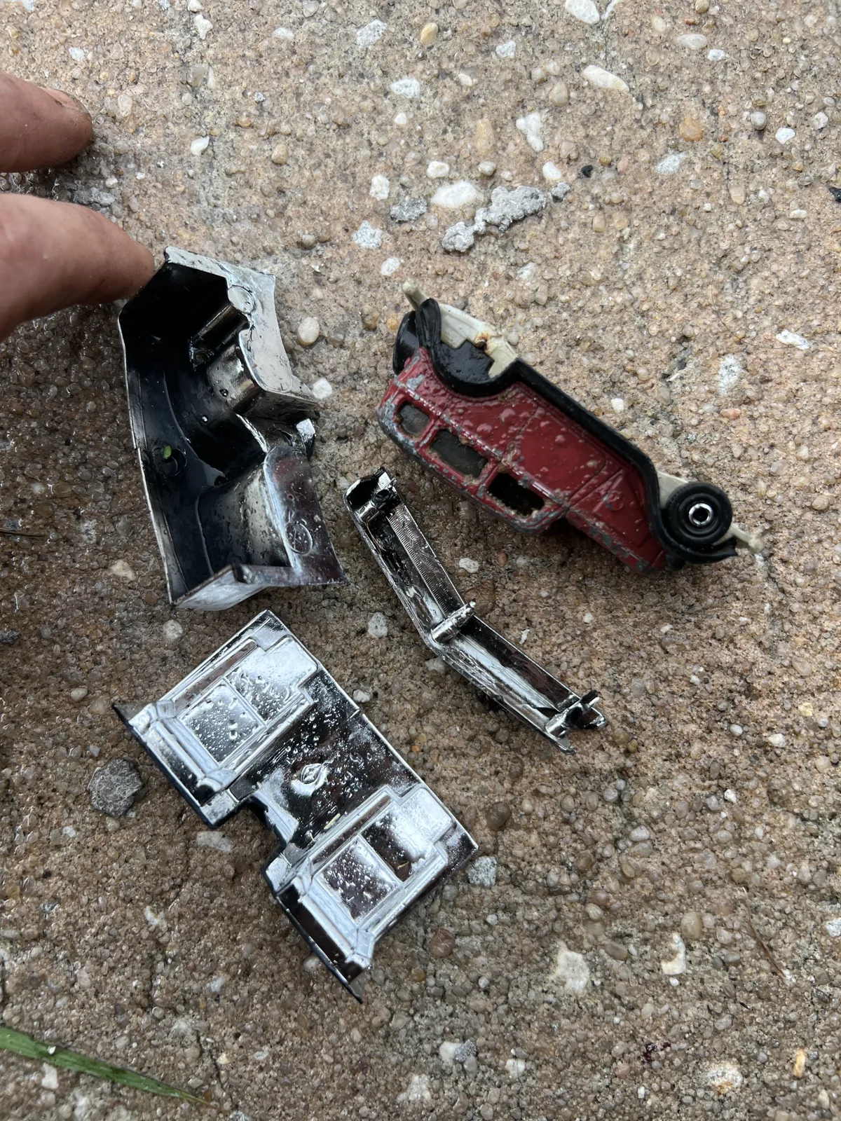 Toy cars and pieces removed from a blocked laundry P-trap