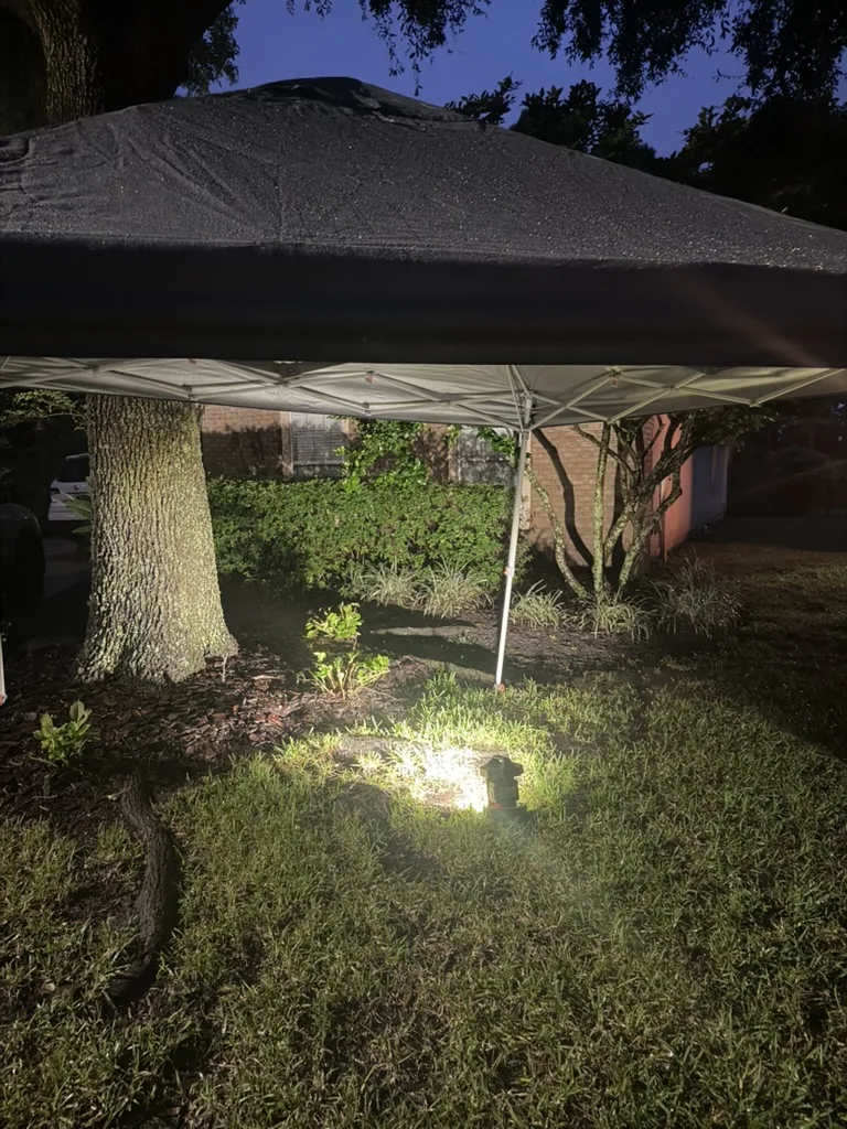 Lighted work area beneath a canopy in the yard during the Pablo Bay water-line repair
