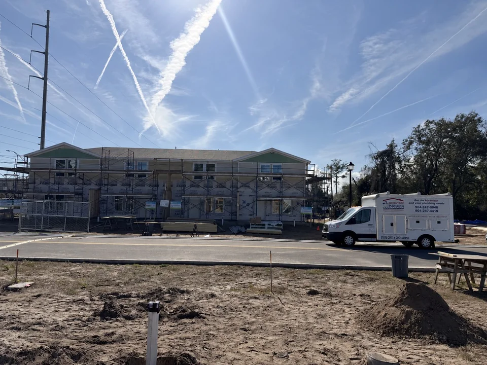 Coastal Haven townhomes under construction with an Advantage Plumbing truck on site