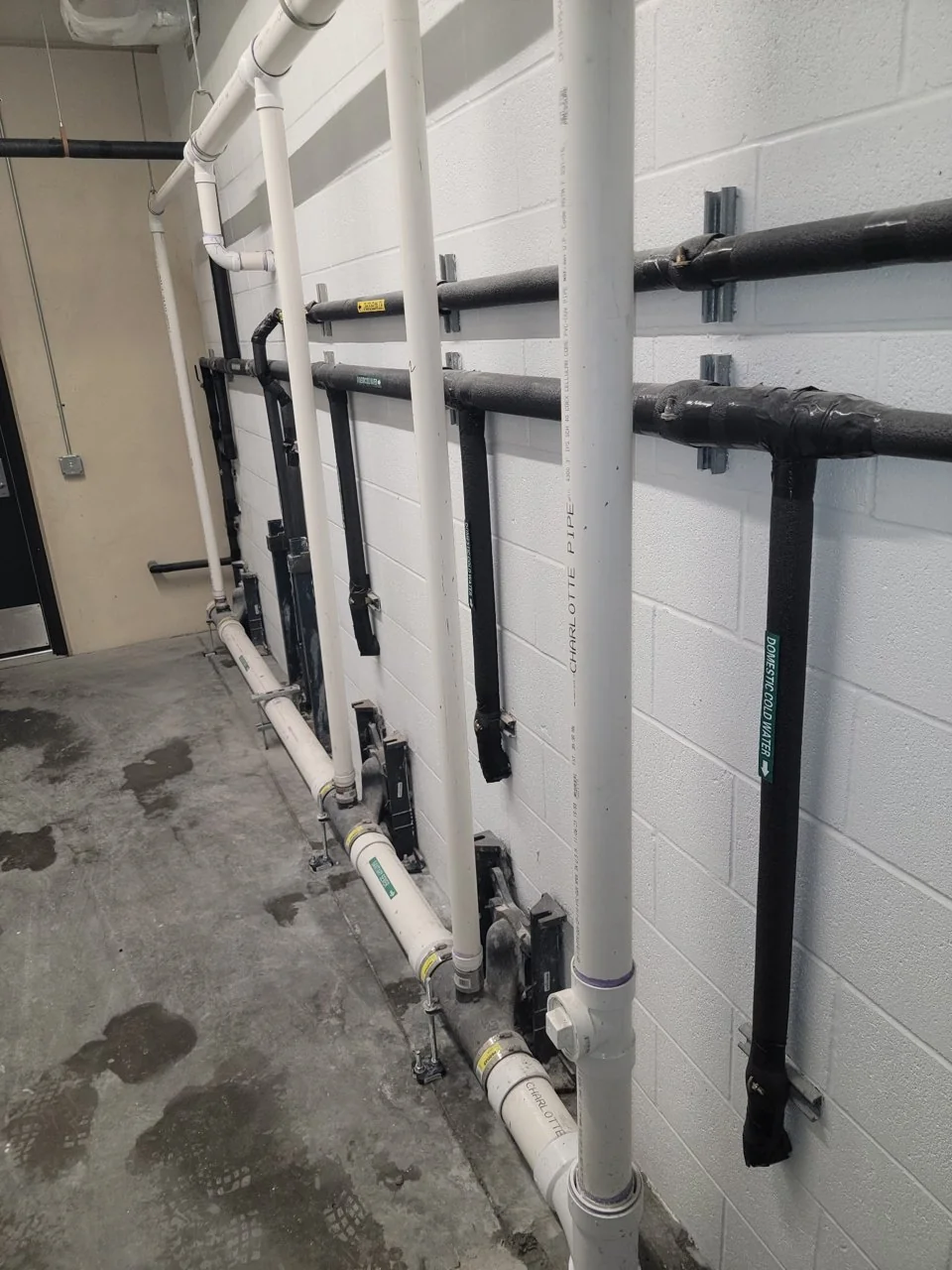 Insulated hot and cold water piping in a recent commercial project mechanical room