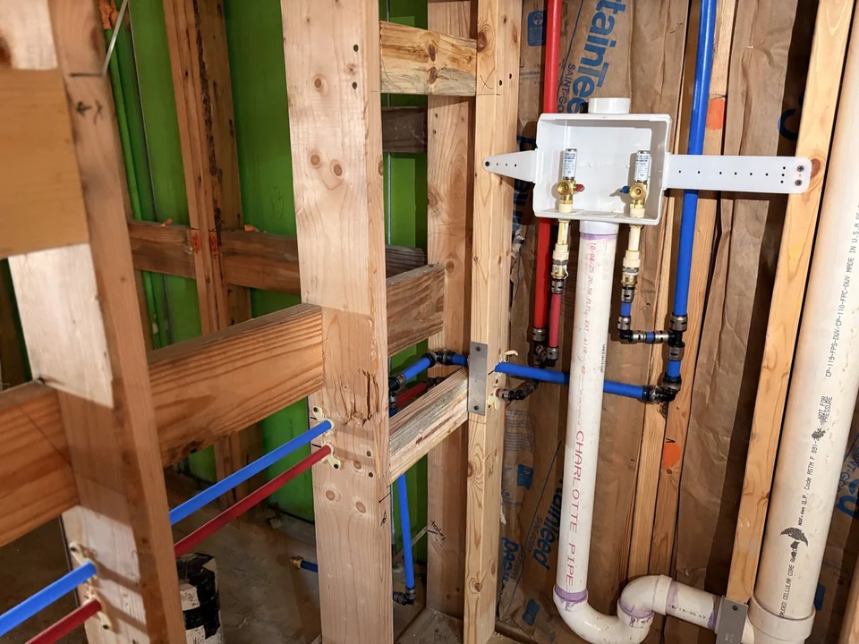 Laundry water supply box and drain rough-in in a framed wall