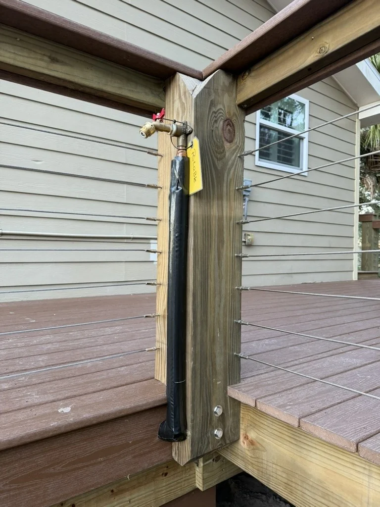 Hose bibb and insulated water line secured to a dock-side railing post