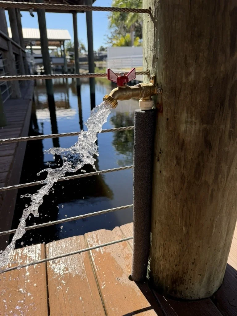 Water flowing from a dock-mounted hose bibb installed by Advantage Plumbing