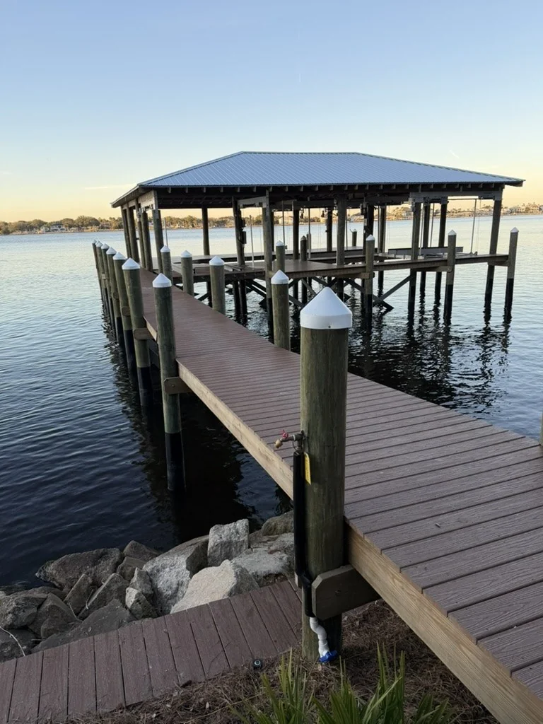 Water line and hose bibb serving a waterfront dock and boat lift