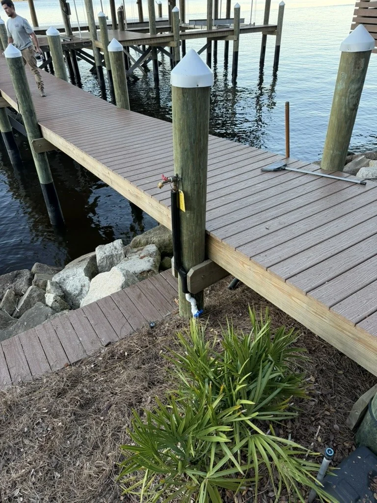 Water supply connection and hose bibb at the entrance to a waterfront dock