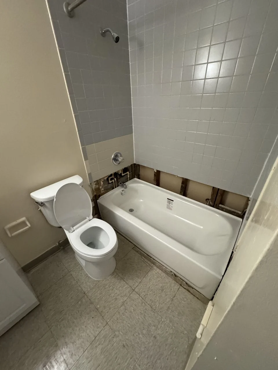 New toilet and bathtub installed for JHA with wall finishing still in progress