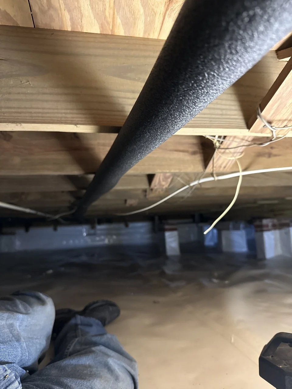 New insulated water line beneath a home’s floor framing