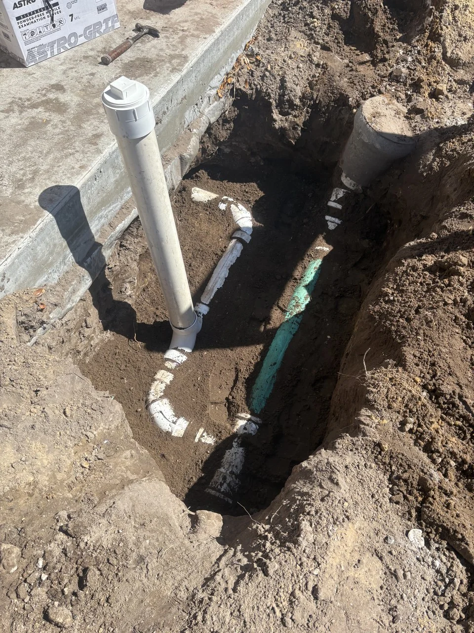 Exposed sewer piping and a cleanout during an Advantage Plumbing sewer-line replacement