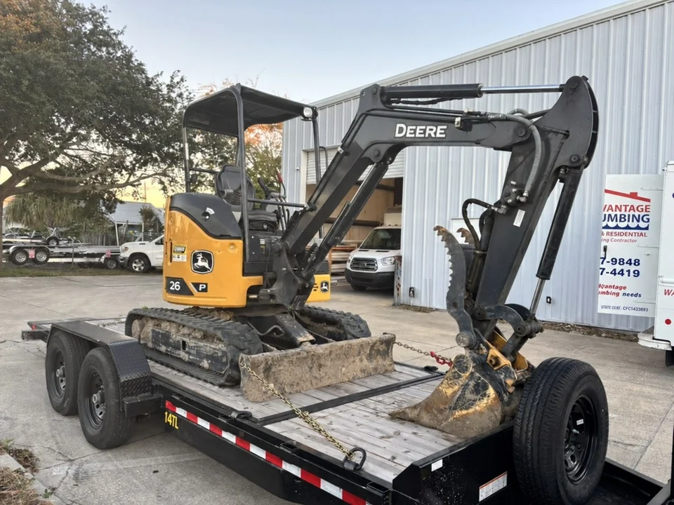 Advantage Plumbing excavator on a trailer for excavation work