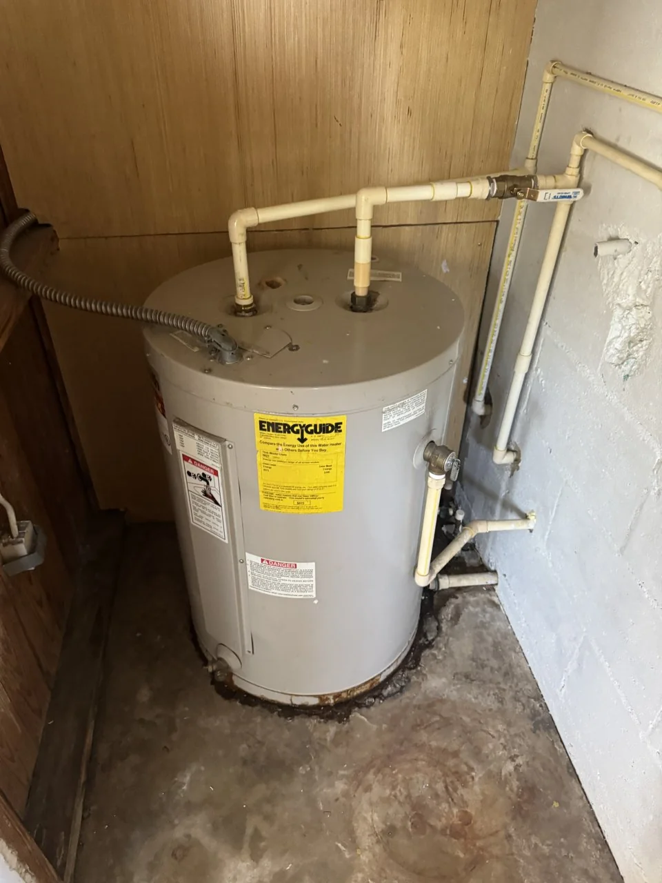 Original tank water heater and connections before replacement