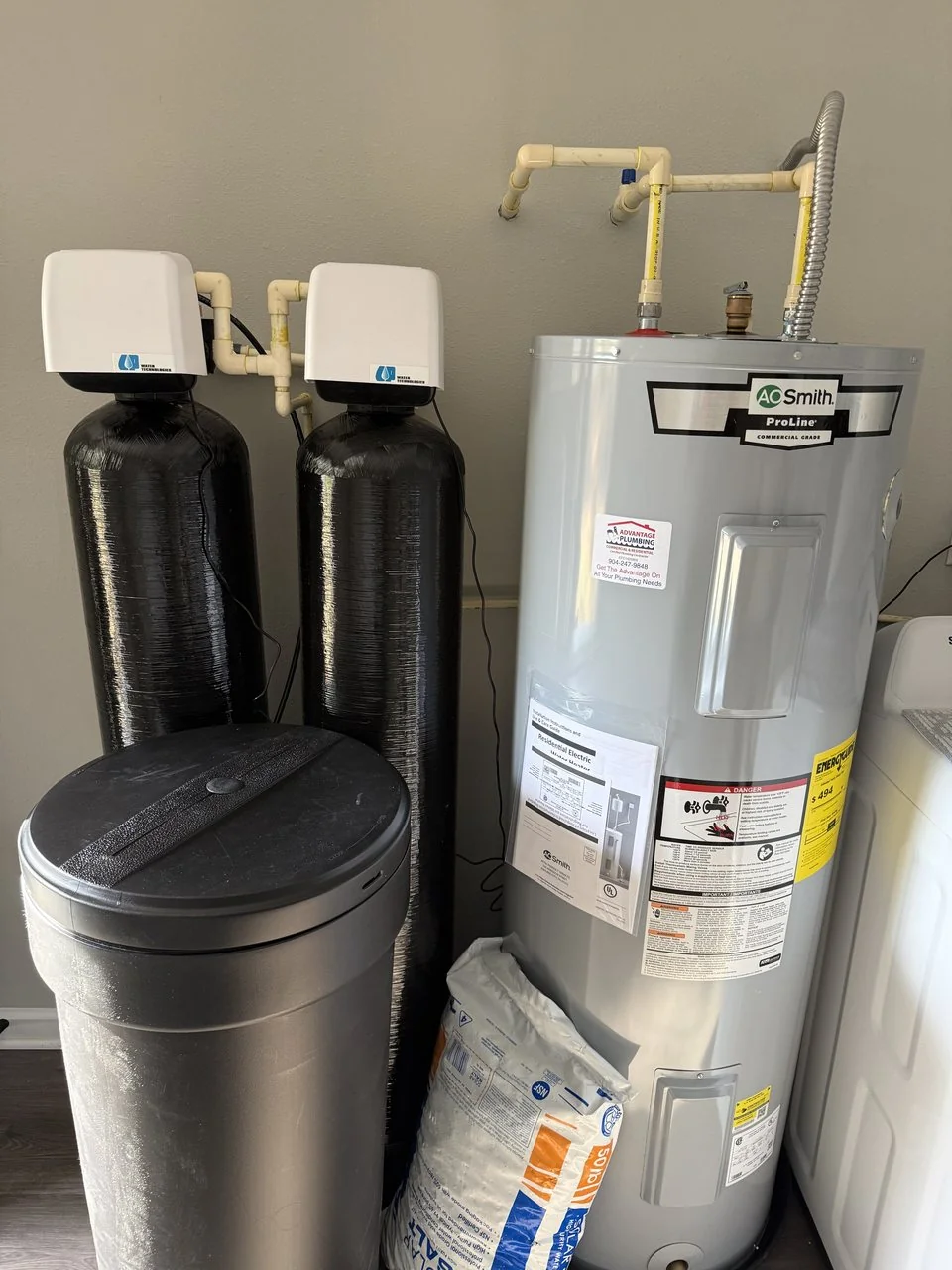 Water-treatment equipment and a water heater installed by Advantage Plumbing